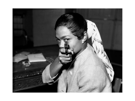 Eartha Kitt - Black and White Portrait Aiming a Pistol, England, 1956 Print
