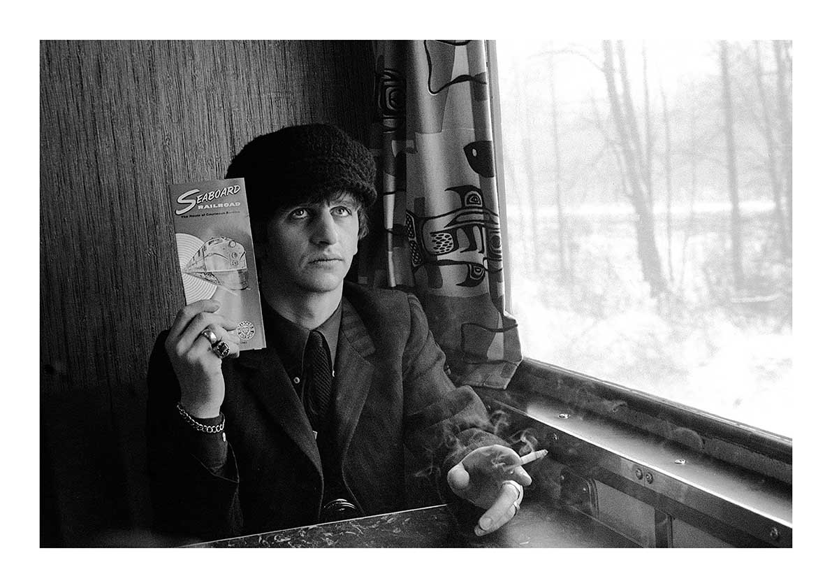 The Beatles - Ringo Starr Holding a Seaboard Railroad Card on the Train After the Ambassador's Party in Washington, February 1964