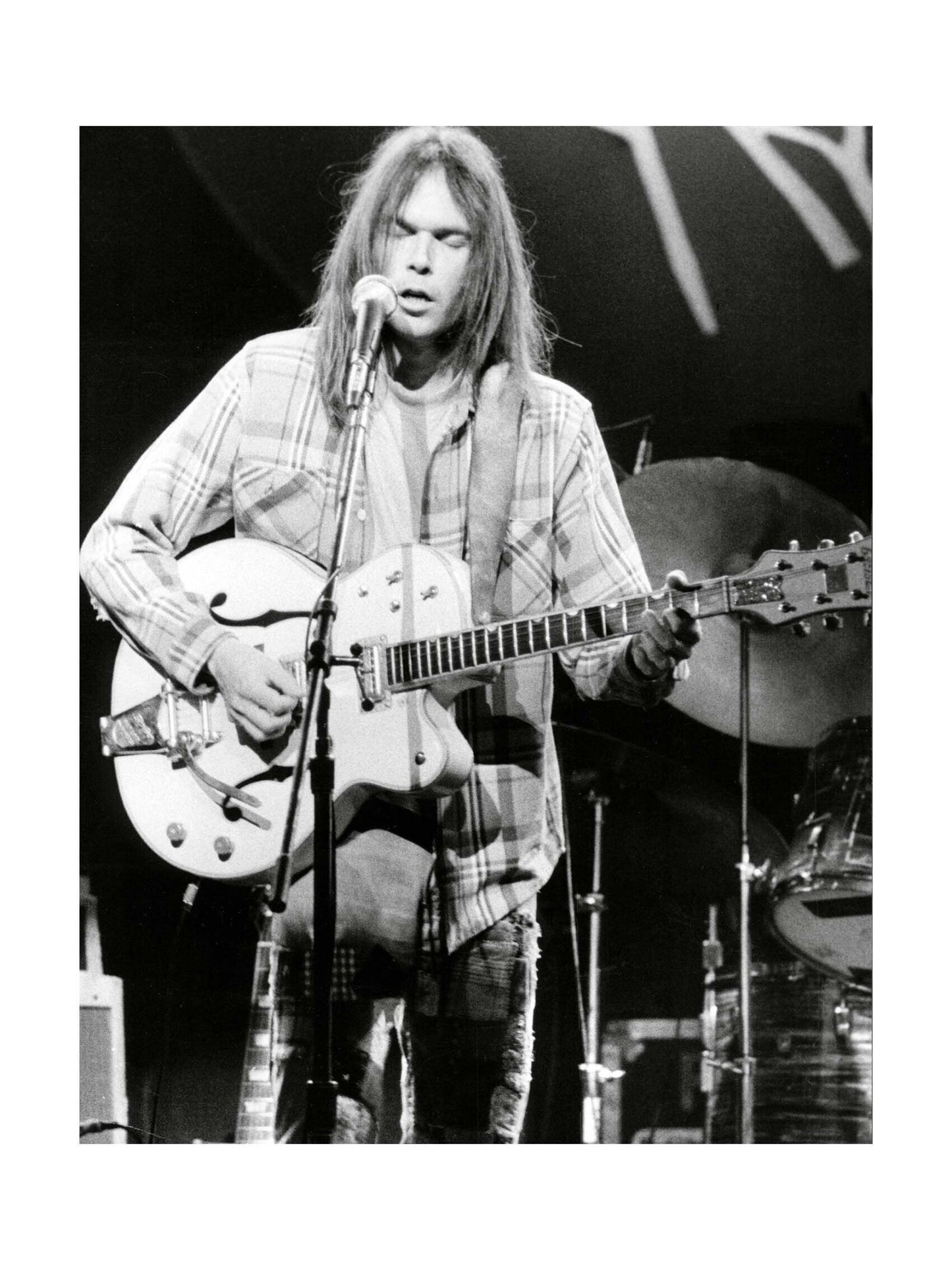 Neil Young - Portrait Singing and Playing Guitar on Stage, 1976 Print